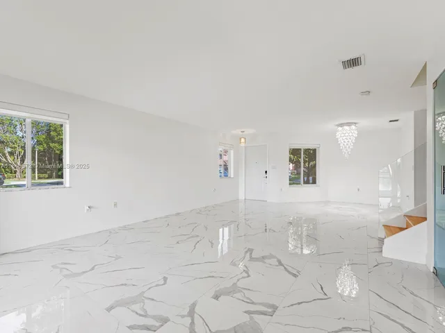 a view of kitchen with refrigerator stove microwave and furniture
