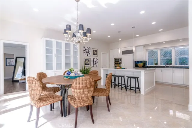 a view of a dining room with furniture and chandelier