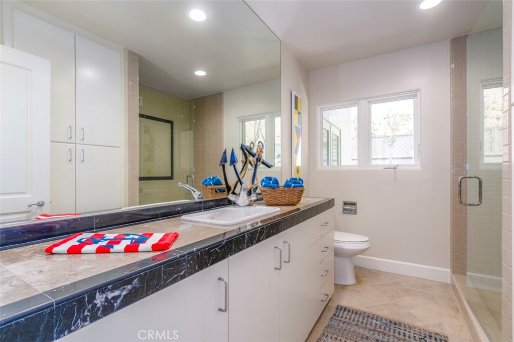 120 Via Trieste Newport Beach, CA 92663 - Photo 19 of 39 a bathroom with a sink and a mirror