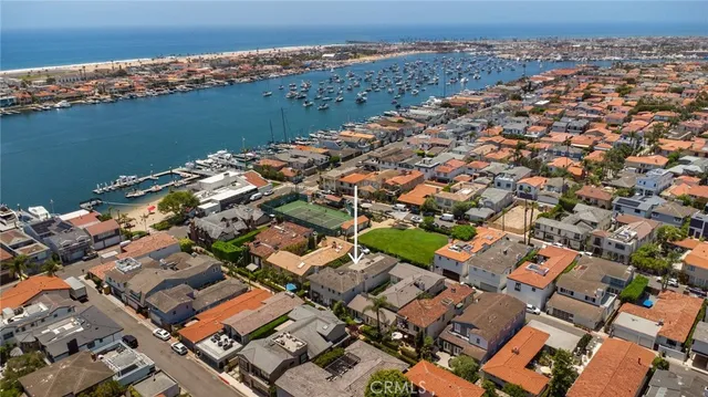 an aerial view of a house with a lake