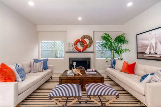 a living room with furniture a rug and a fireplace
