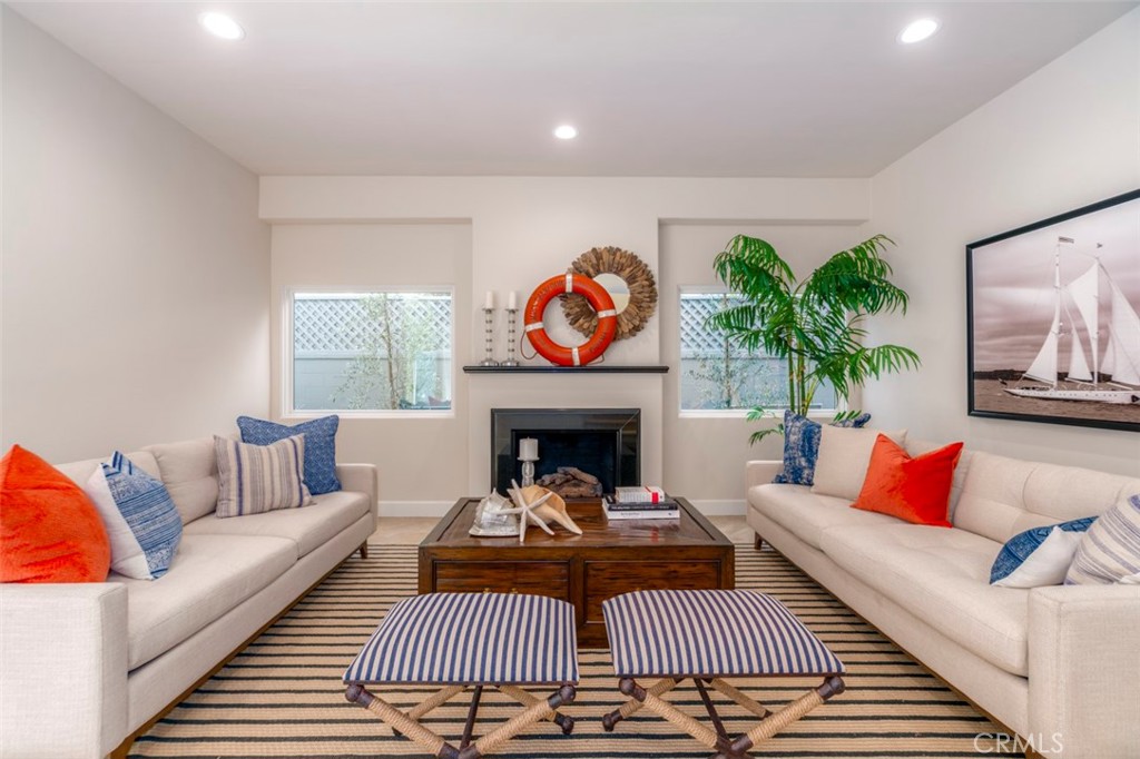 120 Via Trieste Newport Beach, CA 92663 - Photo 3 of 39 a living room with furniture a rug and a fireplace