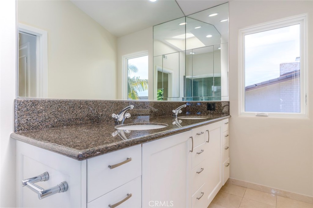 120 Via Trieste Newport Beach, CA 92663 - Photo 32 of 39 a bathroom with a granite countertop sink and a mirror