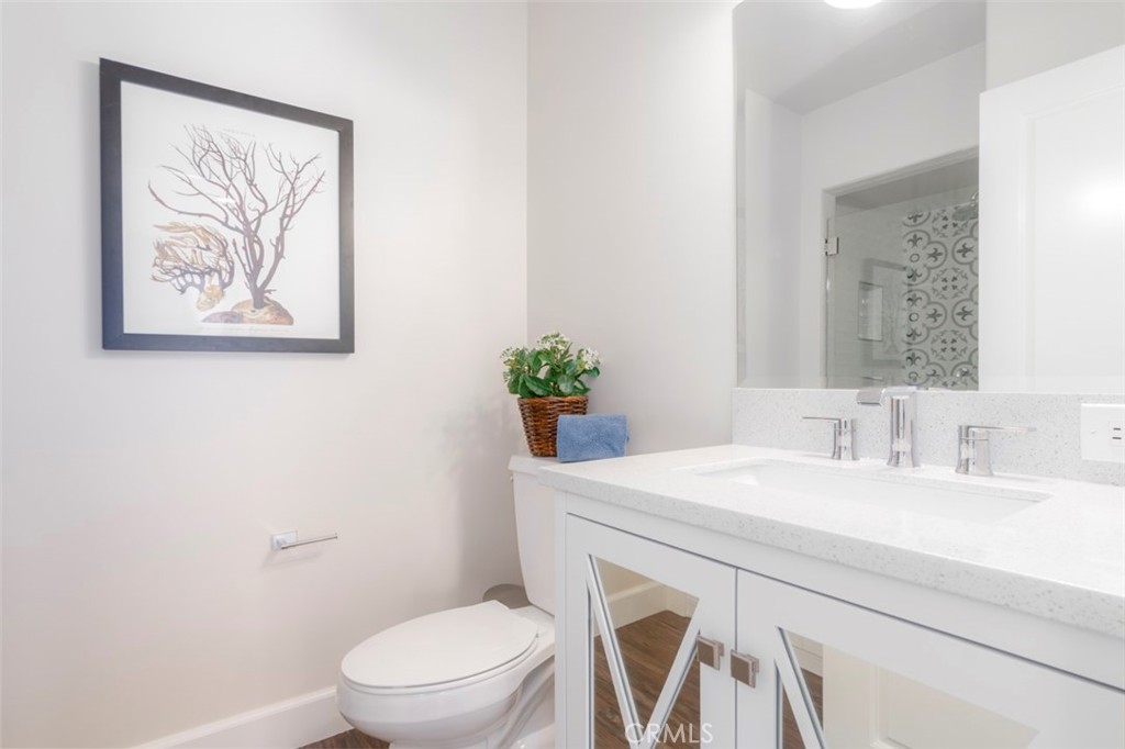 120 Via Trieste Newport Beach, CA 92663 - Photo 35 of 39 a bathroom with a sink mirror vanity and toilet