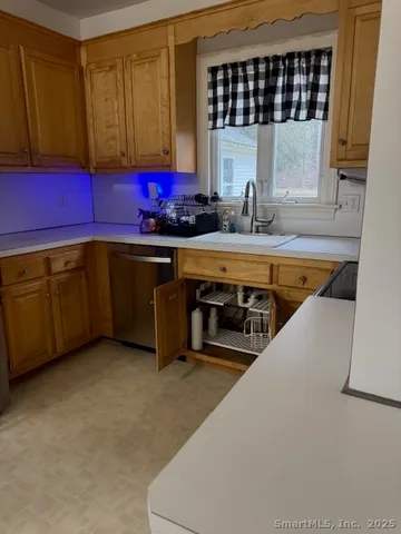 a kitchen with stainless steel appliances a sink a stove and a refrigerator