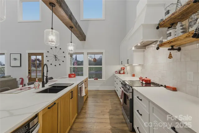 a kitchen with kitchen island a sink stove and wooden floor