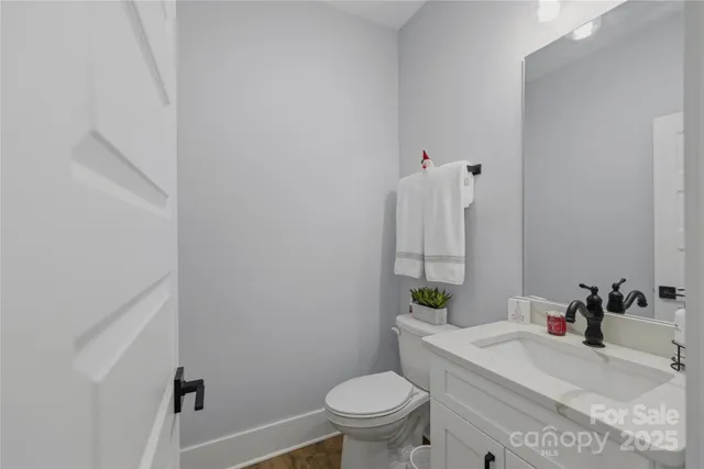 a bathroom with a sink toilet and a mirror