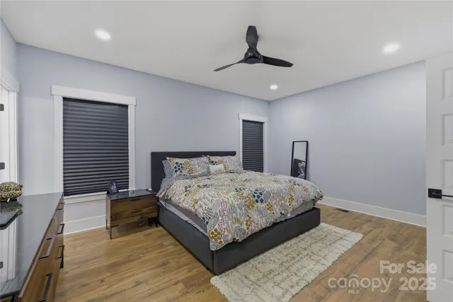 a bedroom with a large bed and a chandelier