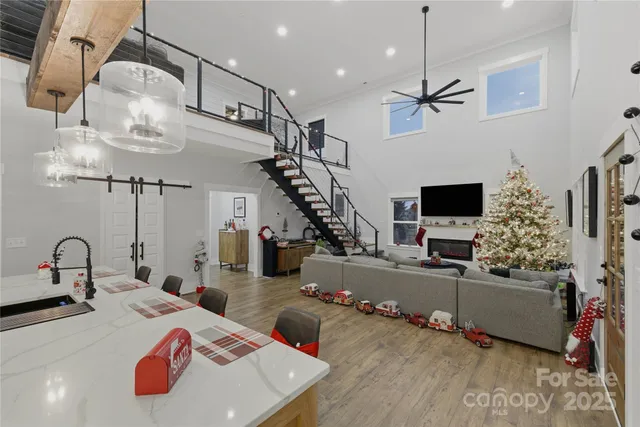 a very nice looking room with kitchen view and a wooden floor