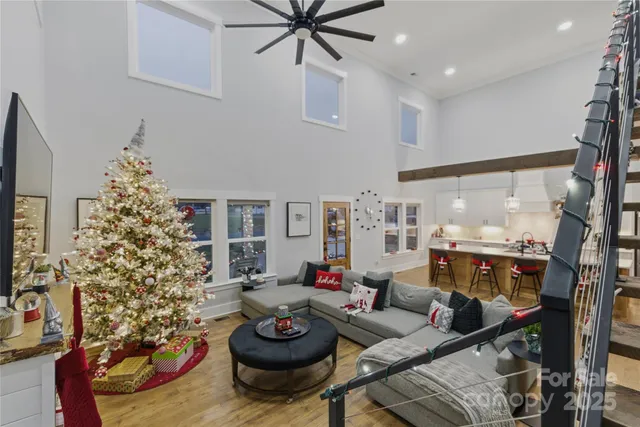 a living room with furniture and a floor to ceiling window
