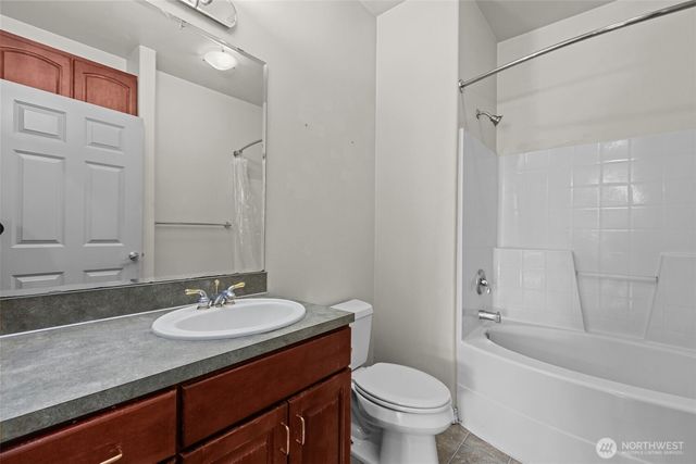 a bathroom with a sink toilet a mirror and shower