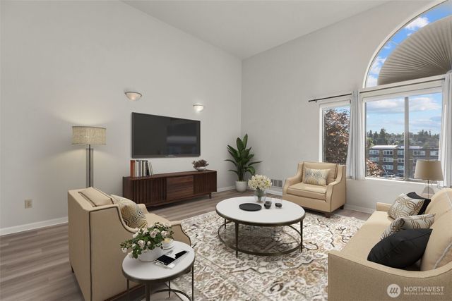 a living room with furniture a rug and a large window