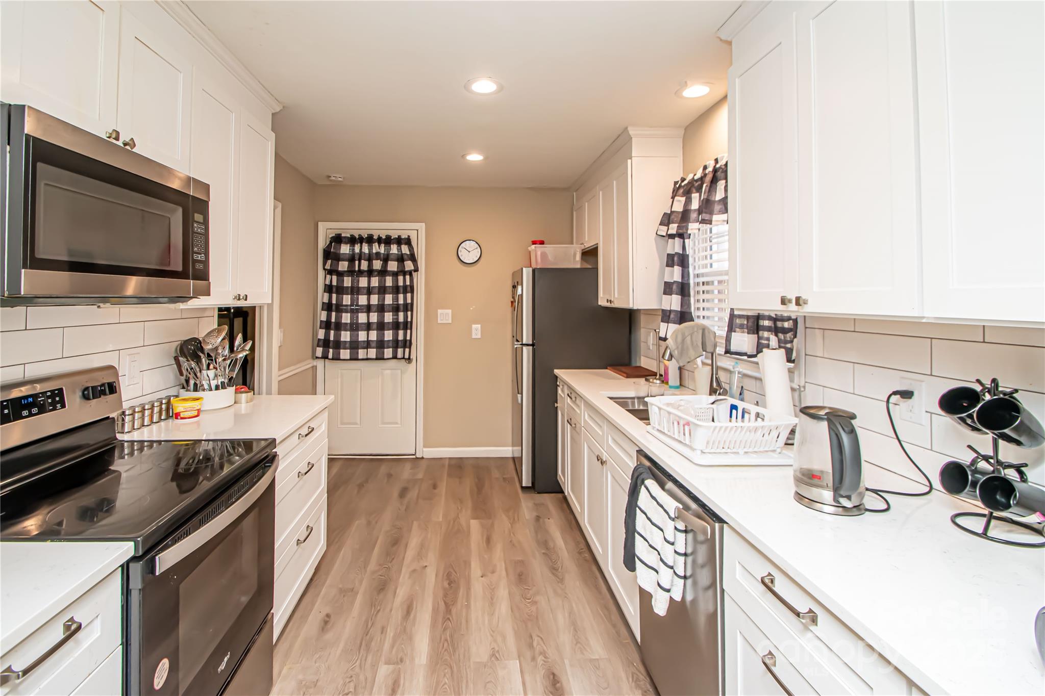 1741 Dallas Avenue Charlotte, NC 28205 - Photo 21 of 40 a kitchen with a sink stove and microwave