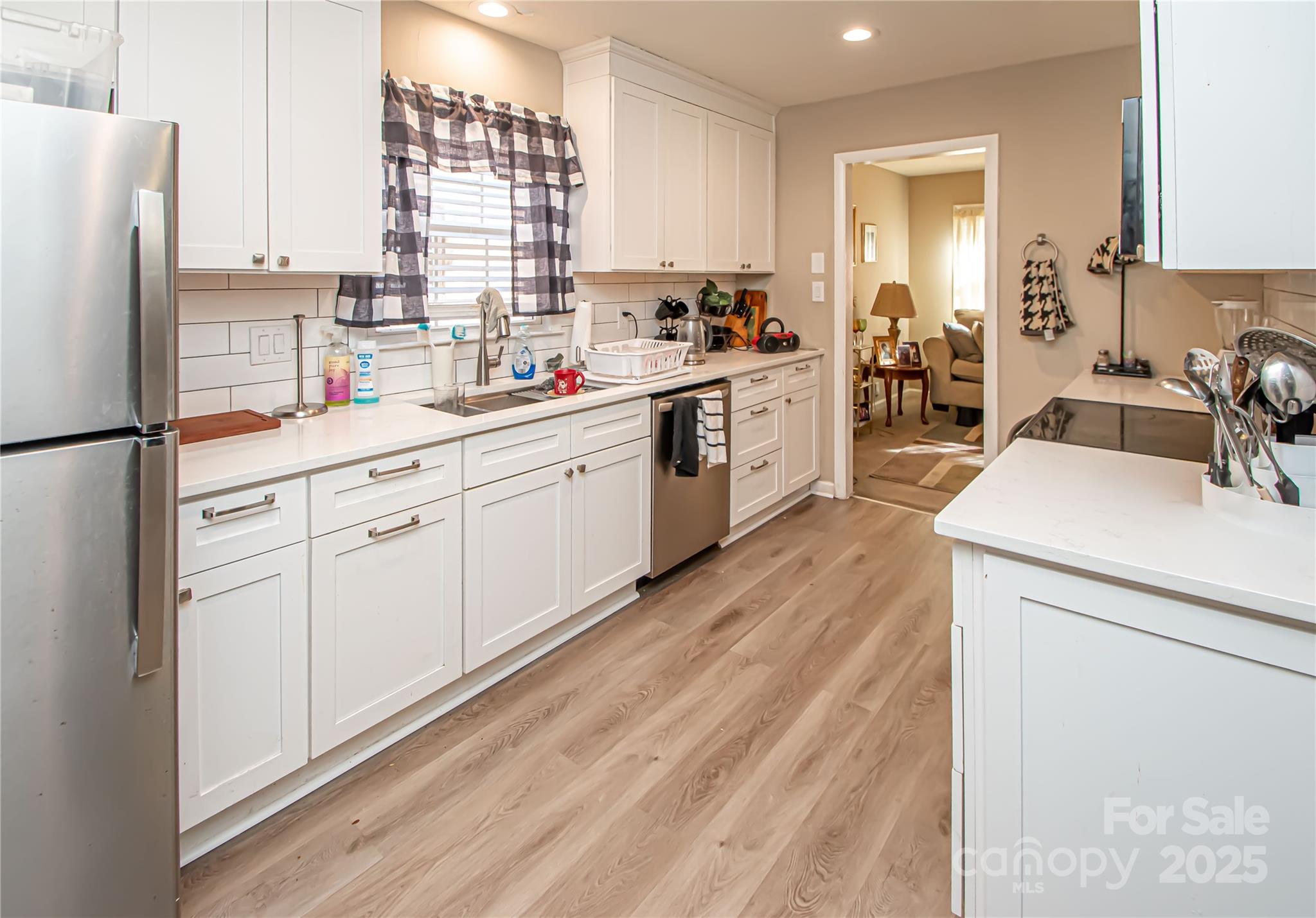 1741 Dallas Avenue Charlotte, NC 28205 - Photo 22 of 40 a kitchen with white cabinets and white appliances