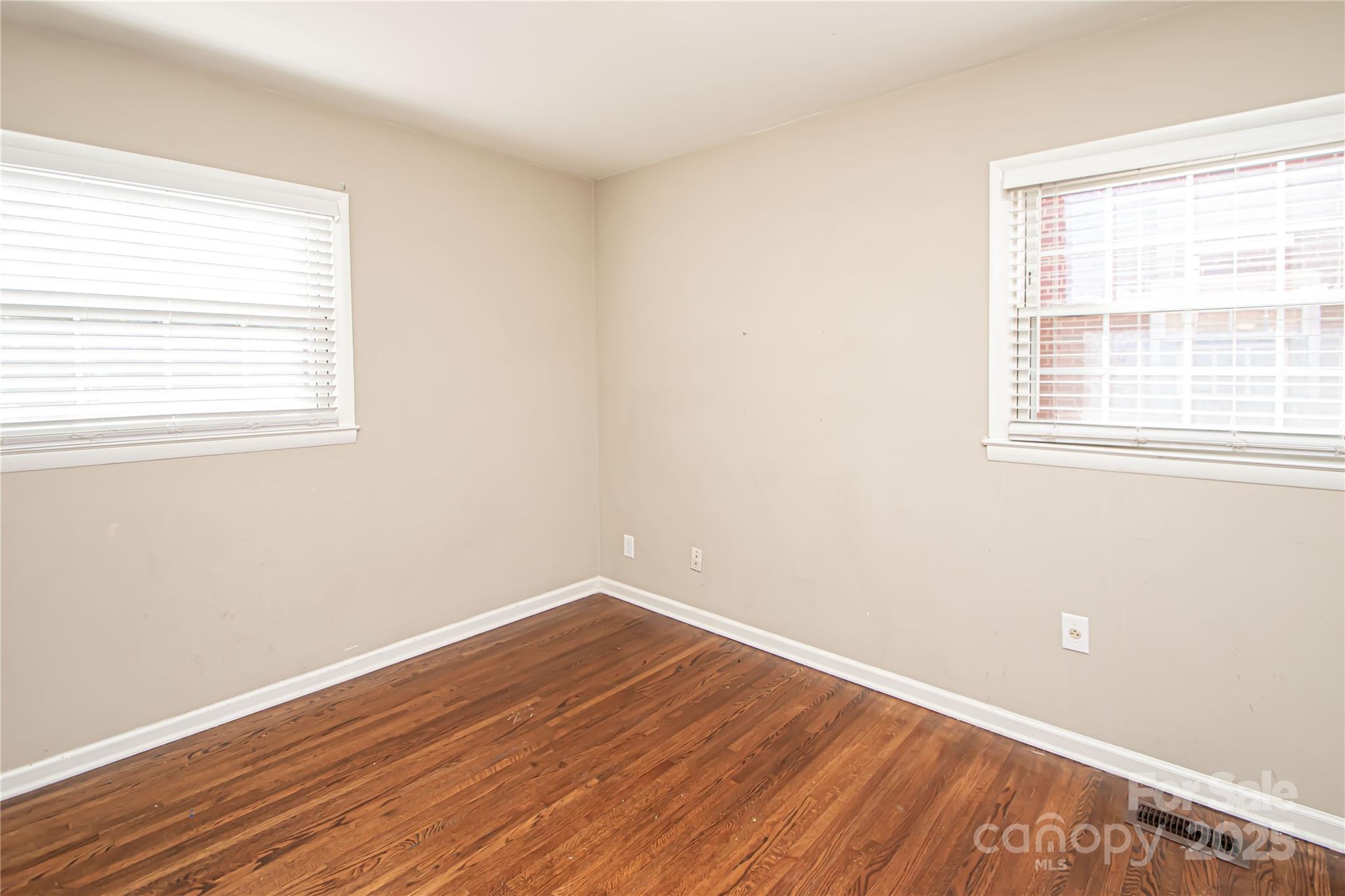 1741 Dallas Avenue Charlotte, NC 28205 - Photo 30 of 40 an empty room with wooden floor and windows