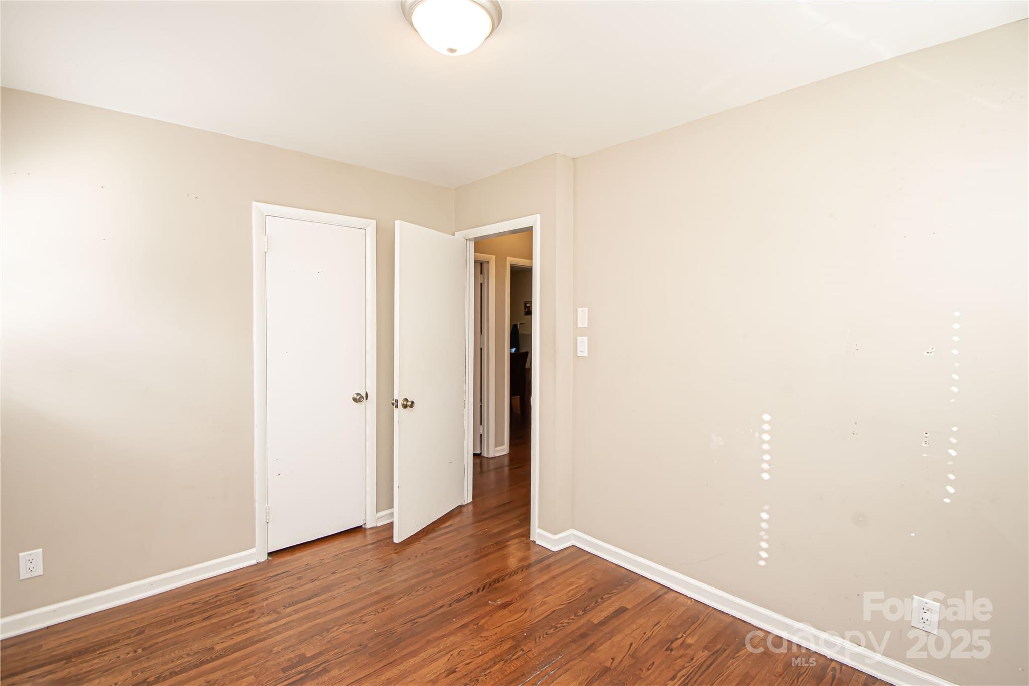 1741 Dallas Avenue Charlotte, NC 28205 - Photo 32 of 40 a view of an empty room with wooden floor