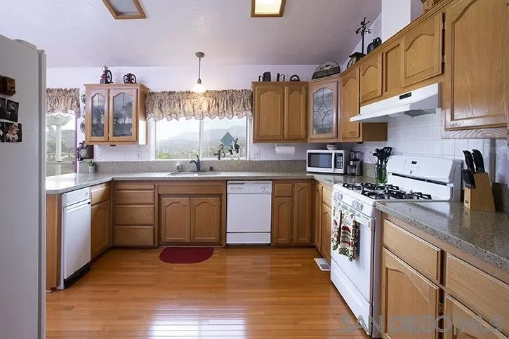854 South Grade Road Alpine, CA 91901 - Photo 3 of 15 a kitchen with a sink stove and cabinets