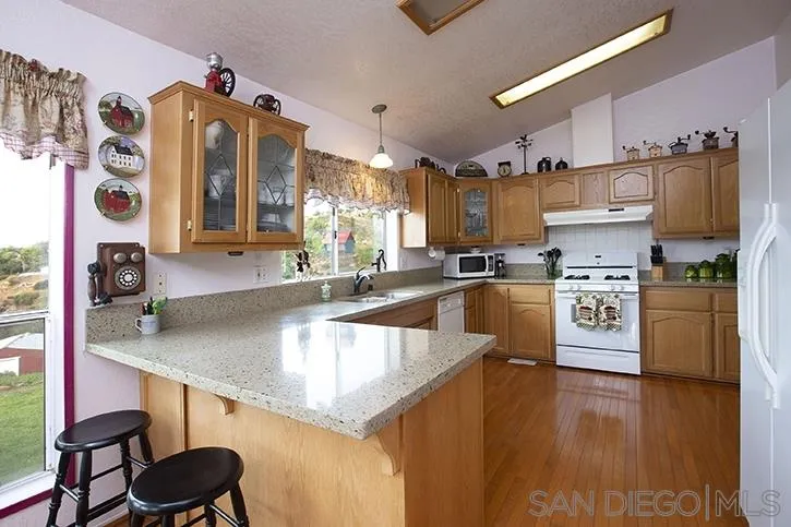 854 South Grade Road Alpine, CA 91901 - Photo 4 of 15 a kitchen with stainless steel appliances granite countertop a sink and cabinets