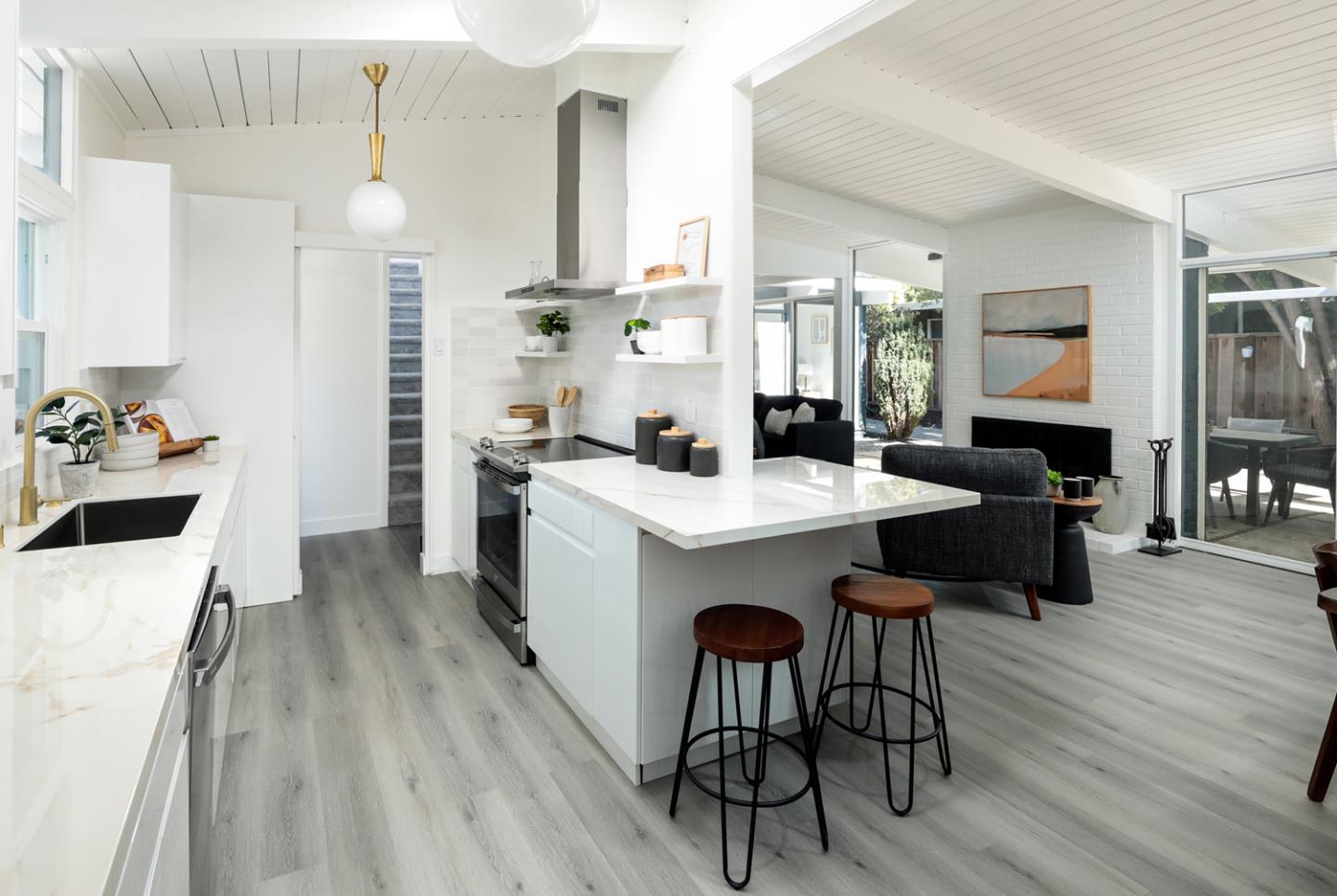 a kitchen with a sink cabinets and wooden floor