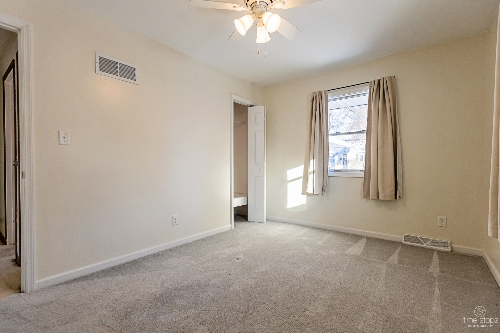 767 Adams Street Ottawa, IL 61350 - Photo 13 of 28 an empty room with windows and chandelier fan