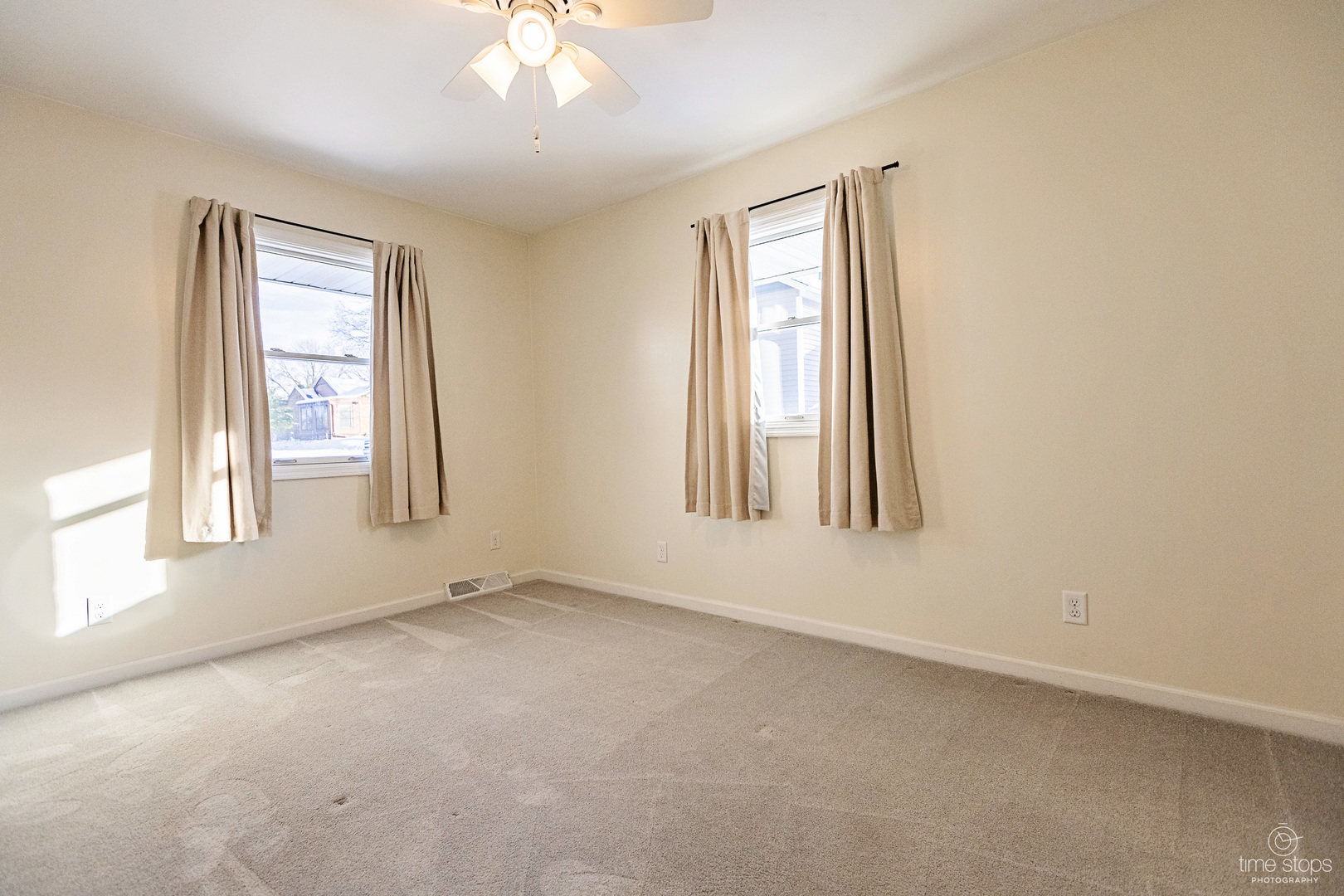 767 Adams Street Ottawa, IL 61350 - Photo 14 of 28 an empty room with windows and chandelier fan