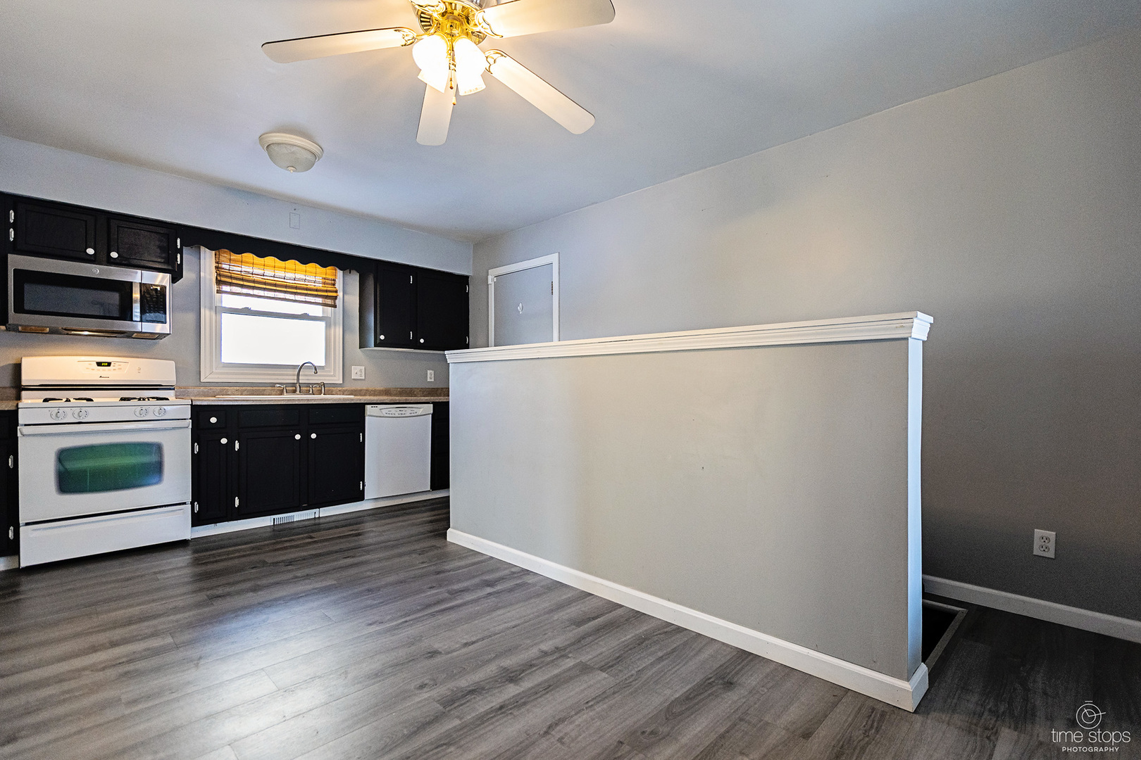 767 Adams Street Ottawa, IL 61350 - Photo 3 of 28 a kitchen with granite countertop a refrigerator and a stove