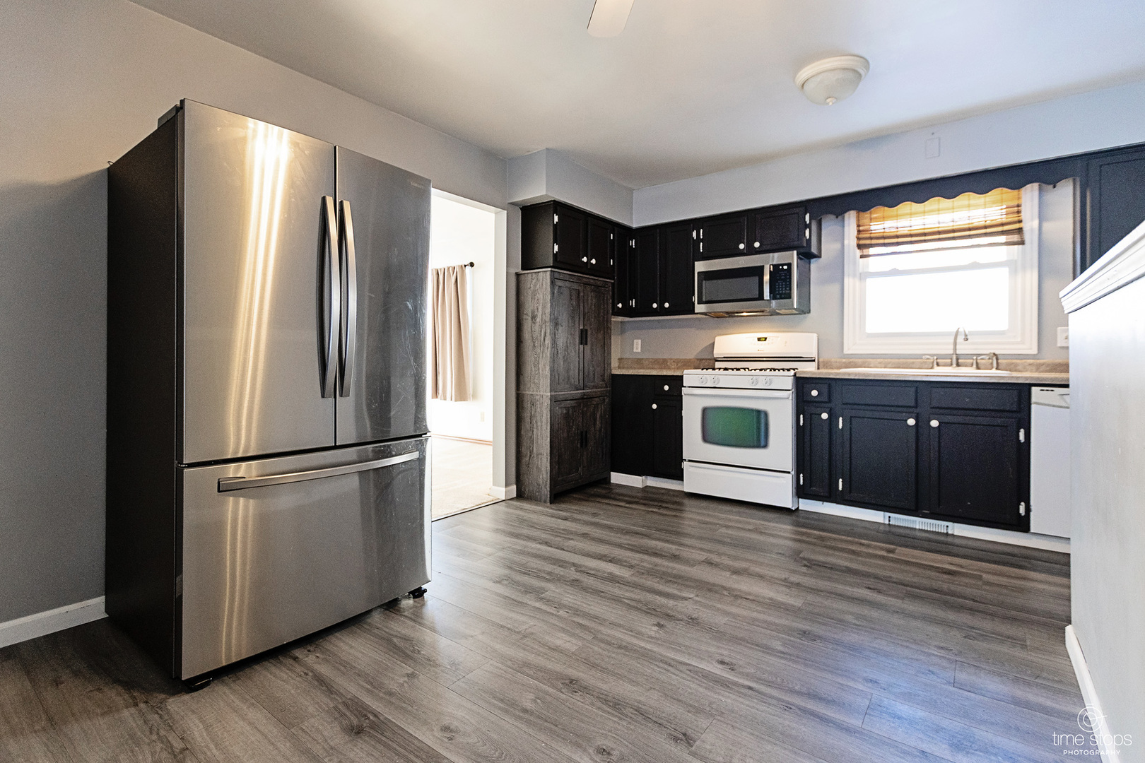 767 Adams Street Ottawa, IL 61350 - Photo 5 of 28 a kitchen with stainless steel appliances wooden cabinets and wooden floor