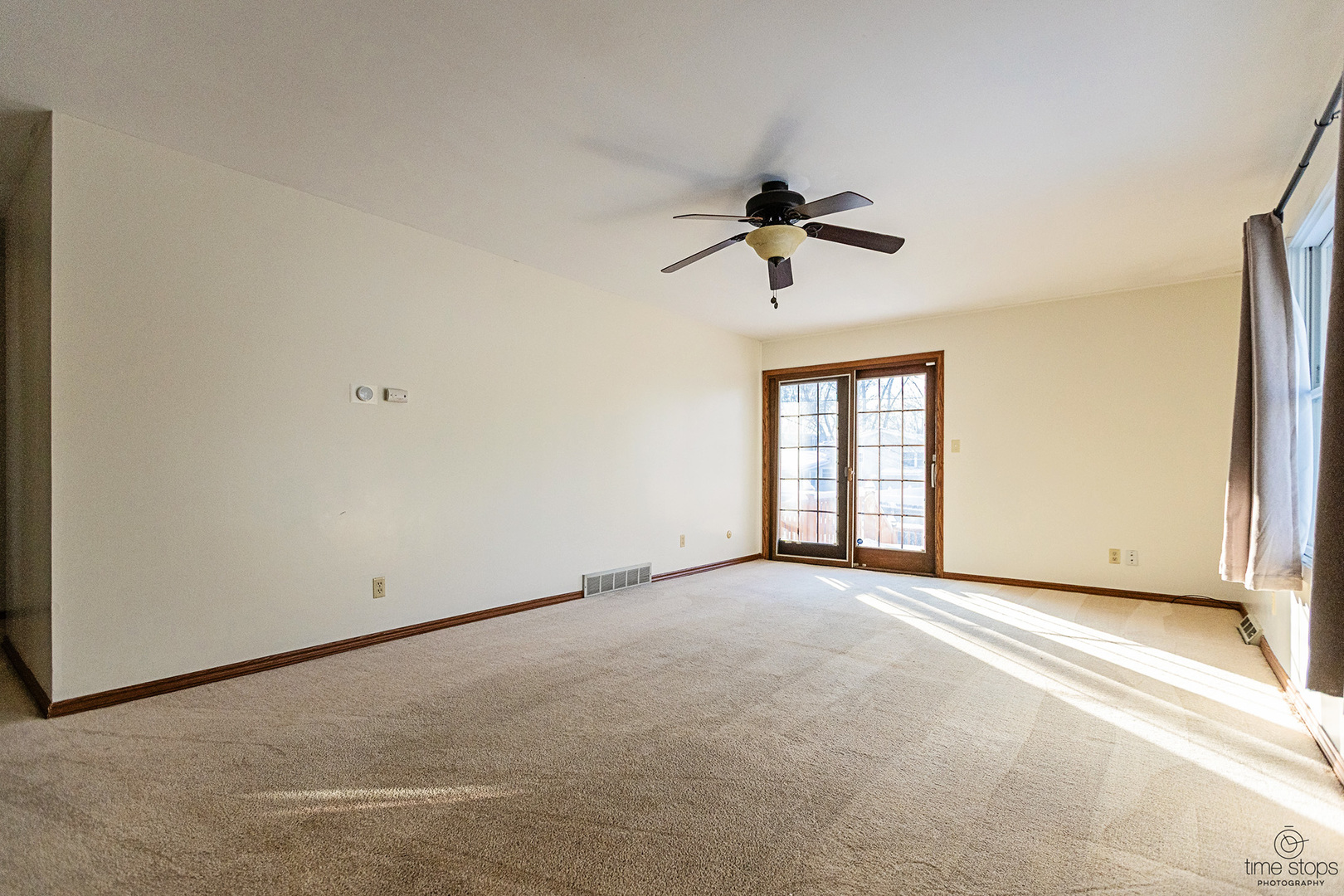 767 Adams Street Ottawa, IL 61350 - Photo 8 of 28 an empty room with chandelier fan and windows