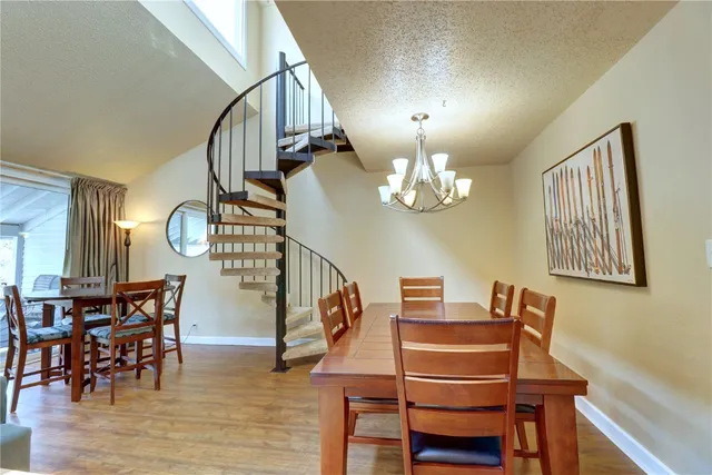 a view of a dining room with furniture and a chandelier