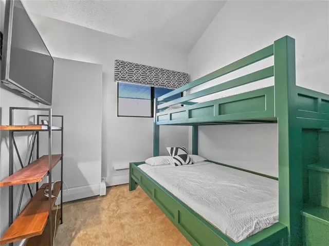 a room with a bed and a mirror