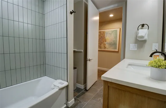 a bathroom with a bathtub and a sink