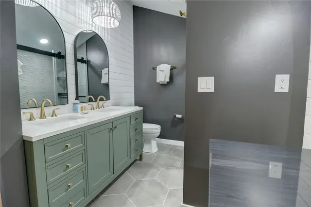 a bathroom with a double vanity sink and a mirror