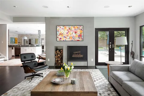 a living room with furniture a flat screen tv and a large window