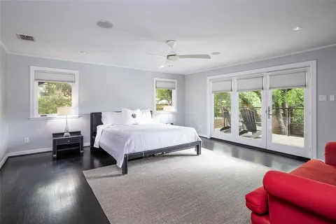 a spacious bedroom with a bed and a couch next to a window