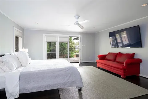 a bedroom with a bed couch and window