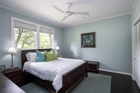 a bedroom with a bed wall painting and a window