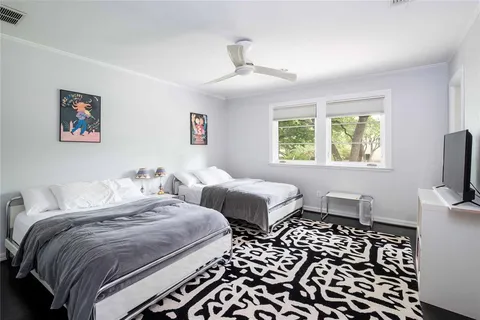 a bedroom with two beds and a tv