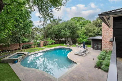 a view of a swimming pool with a yard