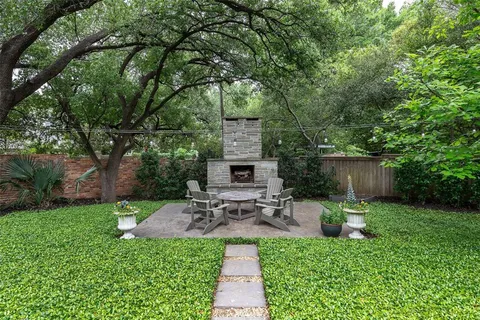 a view of a chair and table in backyard of the house
