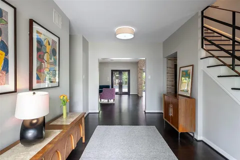 a view of a hallway to a livingroom with furniture