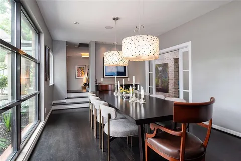 a view of a dining room with furniture a chandelier and wooden floor