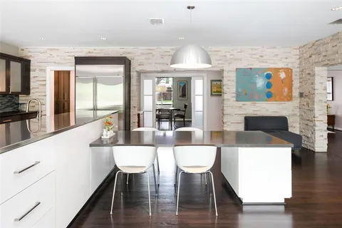 a view of a dining room with furniture wooden floor and chandelier