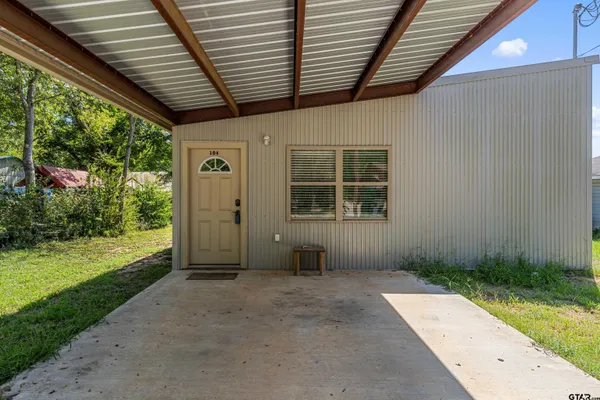 a dining room with kitchen island a sink and a stove with wooden floor