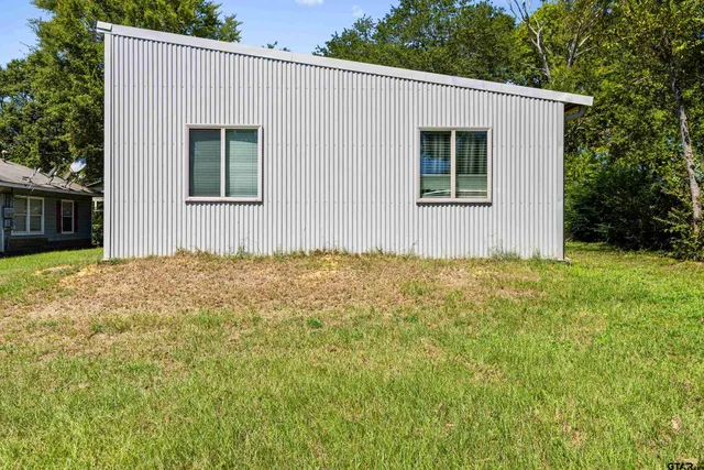 a kitchen with stainless steel appliances granite countertop a sink a stove and a wooden floors