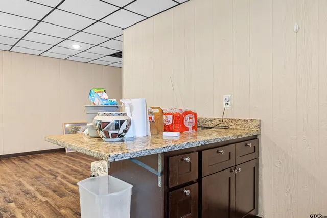 a kitchen with a sink a counter space appliances and cabinets