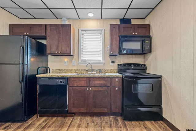 a view of a hallway with wooden floor and a hallway
