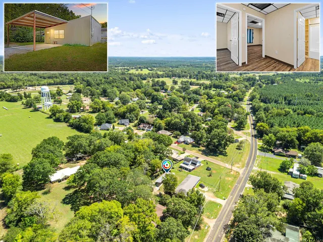 an aerial view of a house with a yard