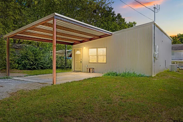 a view of a backyard with a tree