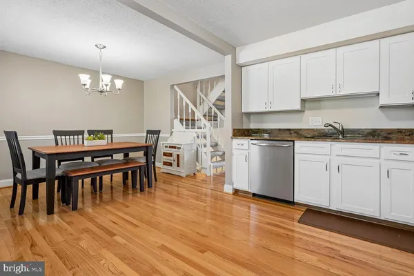 a view of kitchen with cabinets and wooden floor