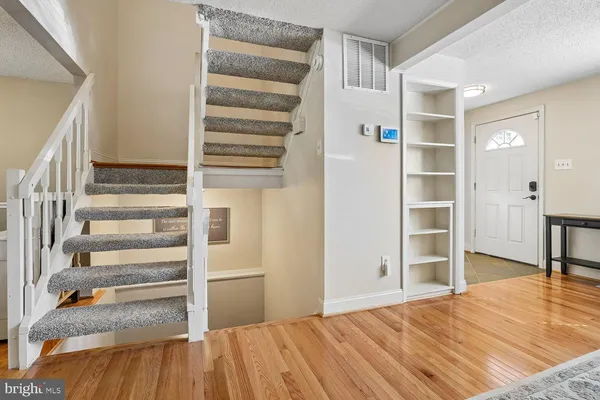 a view of hallway with wooden floor